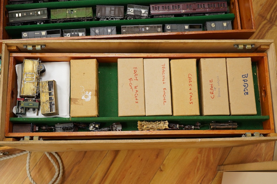 130 items of EM gauge model railway rolling stock contained within three handmade fitted wooden cases, two with removable trays, comprising three locomotives; an SR class 700 0-6-0 tender locomotive, 693, an SR 0-4-0T, 7
